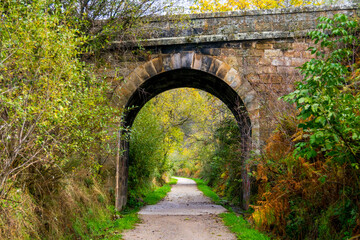 Fototapeta na wymiar It's a greenway where a train used to pass. I passed under this stone bridge.