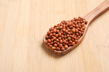 Pigeon pea in wooden spoon on wooden background