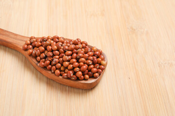 Pigeon pea in wooden spoon on wooden background