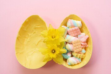 Yellow Easter chocolate egg full of candies. 