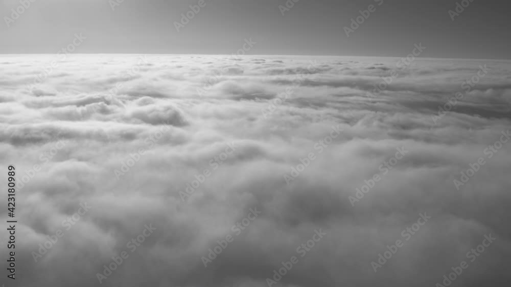 Wall mural view from flying high in heaven airplane. sunny peaceful fluffy white clouds and blue sky with horiz