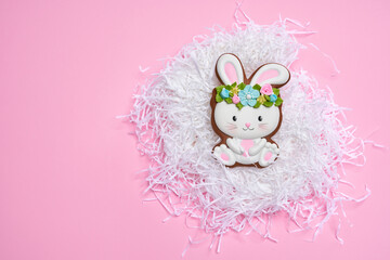 Pink pastel background with Easter bunny cookie