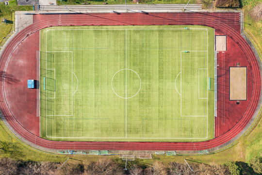 Looking straight down at a soccer field and a cinder track 