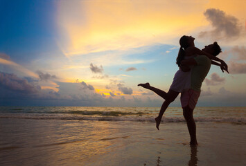 The image of silhouette of two people in love at sunset in Thailand