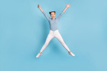 Full length photo of positive pretty young girl jump up air star pose isolated on blue color background