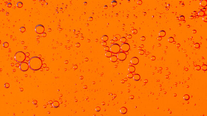 Oil bubbles on the water surface in motion, on a yellow-red background, macro, splash screen, template, copy space