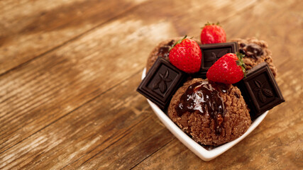 Chocolate ice cream in a bowl. Dessert decorated with chocolate and strawberries