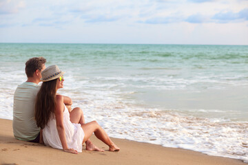 Vacation couple on beach together in love holding around each other