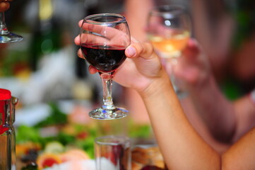 hands holding glasses of wine at the festive table