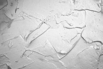 Putty on the wall background. Close-up of a thick layer of putty on the surface. Wall textured surface.