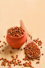 Pigeon pea in bowl on wooden board.