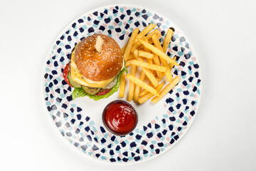 Burger with fries and ketchup on a plate