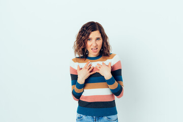 Displeased angry young woman points to herself