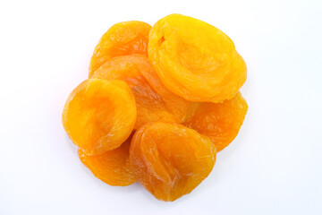 Naklejka na ściany i meble Dried apricots on a white background top view. Dried fruits for tea. Large dried apricots close-up.