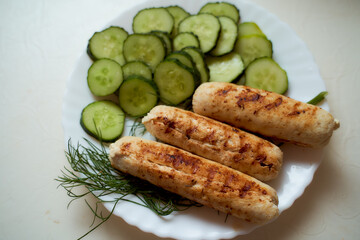 Homemade food. Grill chicken sausages with cucumbers