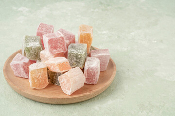 colorful Turkish delights on the plate on green