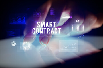 Finger touching tablet with business graphs and icons concept