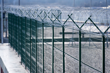 Obraz premium protection fence with barbed wire, barbed wire wall