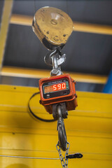 Huge industrial scales in a factory suspended from a crane