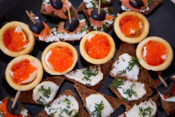 Canape with red caviar and other snacks. View from above