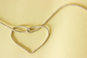A heart shaped knot made of white rope. Love concept.