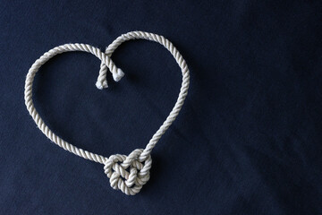 A heart shaped knot made of white rope. Love concept.