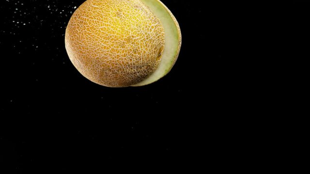 Super slow motion of cutting flying cantaloupe