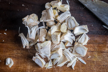 Young tender pieces jackfruit on wooden chopping board with knife. Vegan meat alternative and healthy lifestyle