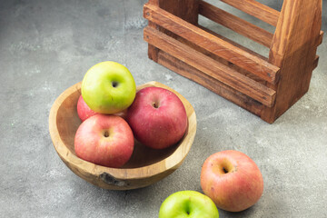Buah Apel or apples fruits on grey grainy wooden background. Copy space for text and template. 