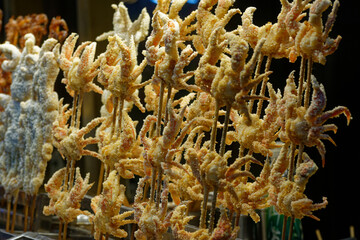 Grilled crab skewer in the muslim street in Xi'an. Asian street food.