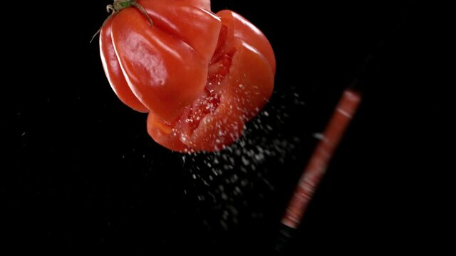 Super slow motion of cutting tomato