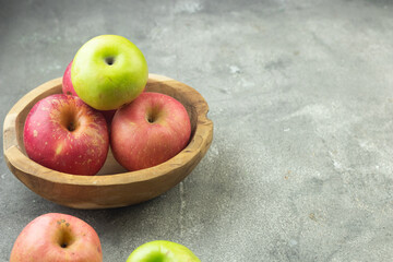 Buah Apel or apples fruits on grey grainy wooden background. Copy space for text and template. 