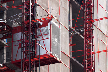 Elevator used for worker and moving materials, Construction site, Passenger lift system outdoor, Industrial machine engine and mechanical workplace, Development land and residential building in city.