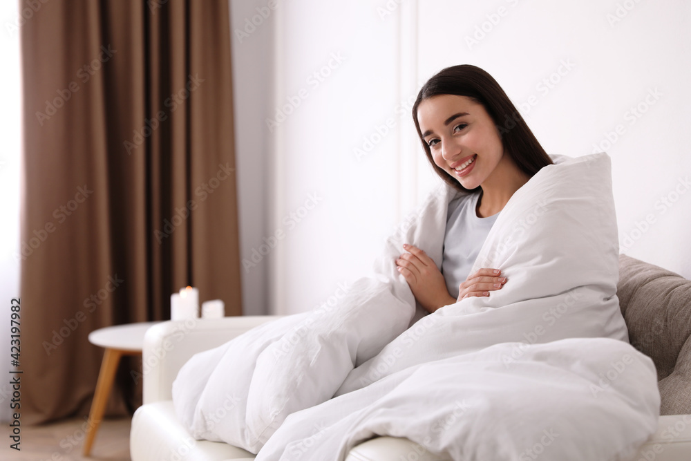 Canvas Prints Woman covered in blanket resting on sofa, space for text