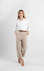 Full length portrait of beautiful young businesswoman on white background