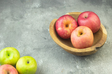 Buah Apel or apples fruits on grey grainy wooden background. Copy space for text and template. 