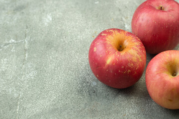 Buah Apel or apples fruits on grey grainy wooden background. Copy space for text and template. 