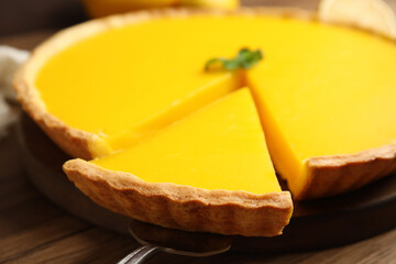 Delicious homemade lemon pie on wooden table, closeup