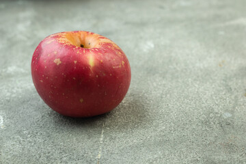 Buah Apel or apples fruits on grey grainy wooden background. Copy space for text and template. 