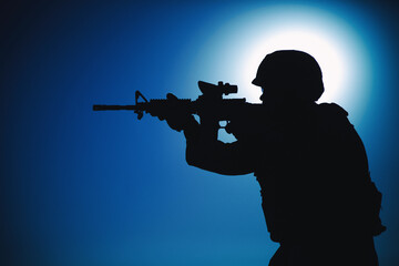 Modern army infantry soldier, coast guard rifleman aiming assault rifle with collimator sight at...