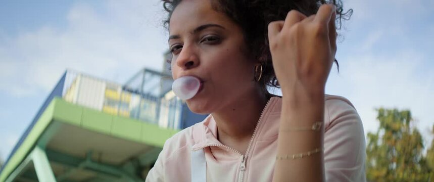 Close up video of beautiful Brazilian woman with chewing gum. Shot with RED helium camera in 8K.