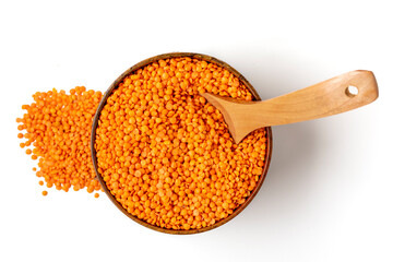 Raw seeds of orange lentils in wooden bowl, spoon isolated on white background Top view Flat lay Healthy eating, vegetable protein concept Traditional Turkish food