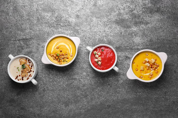 Obraz na płótnie Canvas Different tasty cream soups on grey table, flat lay