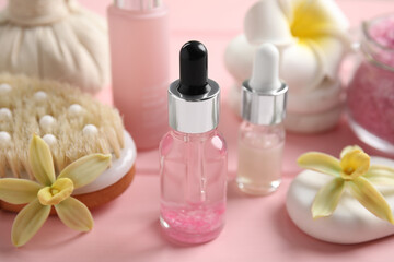 Plakat Composition with spa cosmetic and flowers on pink wooden table, closeup