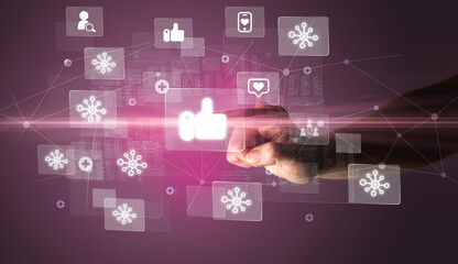 Hand pressing social media multimedia application screen with media icons on futuristic concept