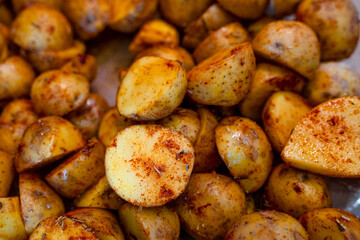 New potatoes cut in half and marinated with rosemary and paprika. Beautiful food background