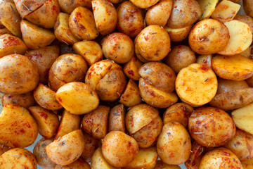 New potatoes cut in half and marinated with rosemary and paprika. Beautiful food background