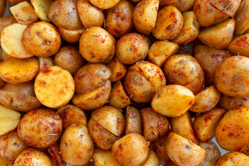 New potatoes cut in half and marinated with rosemary and paprika. Beautiful food background