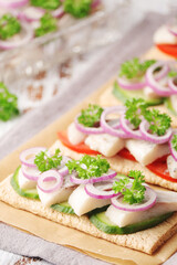 Sandwiches with herring and vegetables