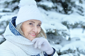 Happy beautiful senior woman in warm hat